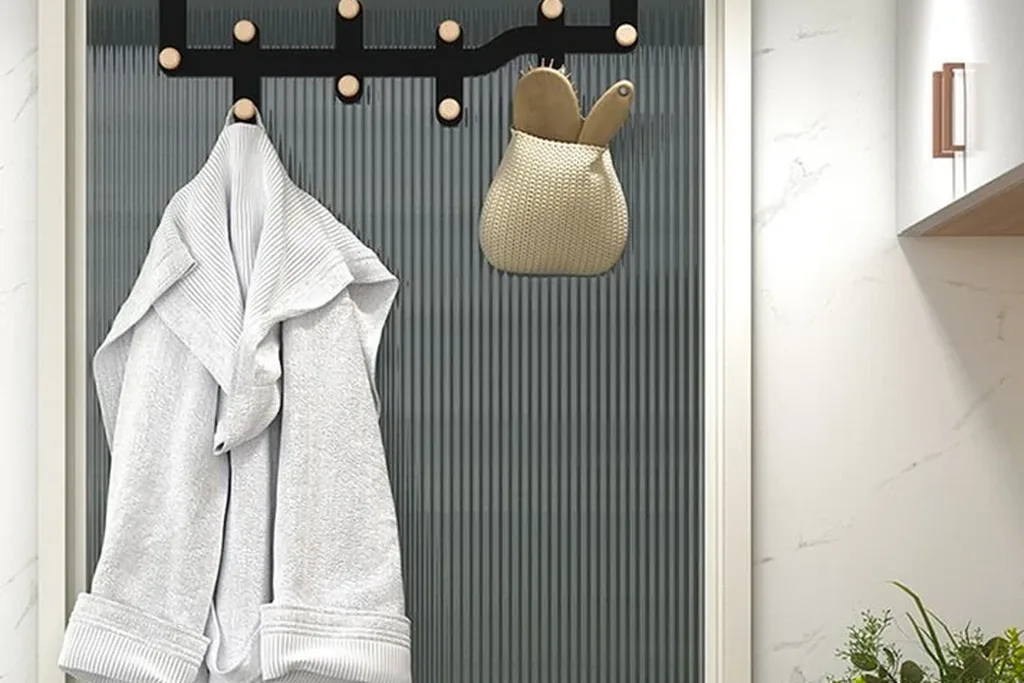 Over door hooks on a bedroom door holding a robe and a bag.