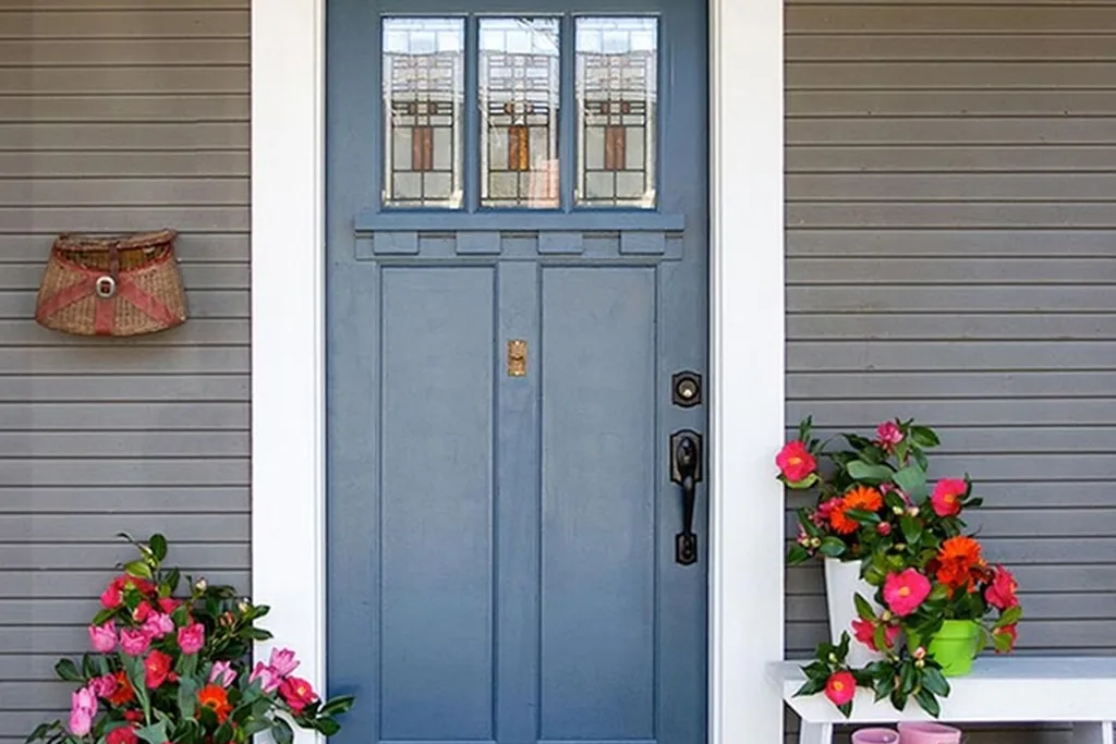Front door painted soft blue gray on a house exterior.