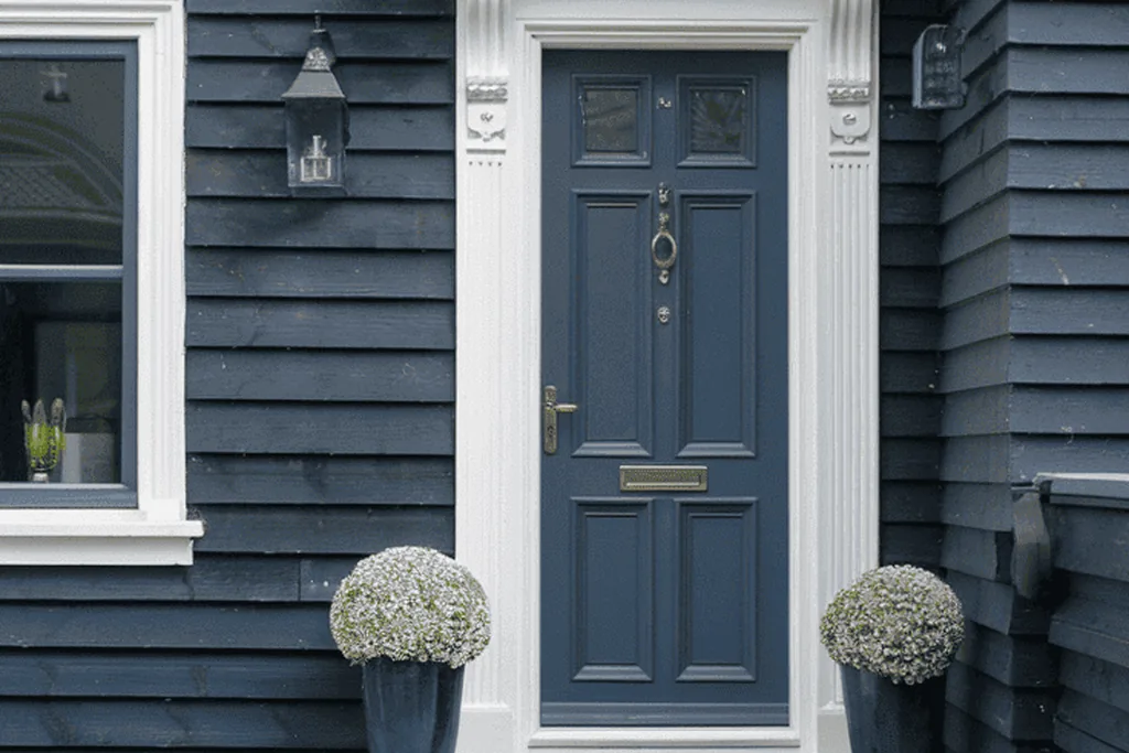 Front door painted muted colonial blue on a traditional house.