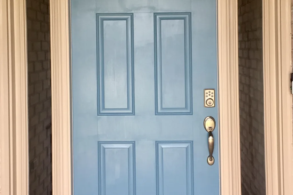Front door painted casual denim blue on a house exterior.