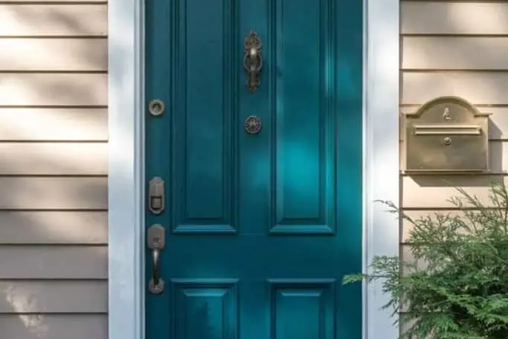 Front door painted dark petrol blue green on a house exterior.