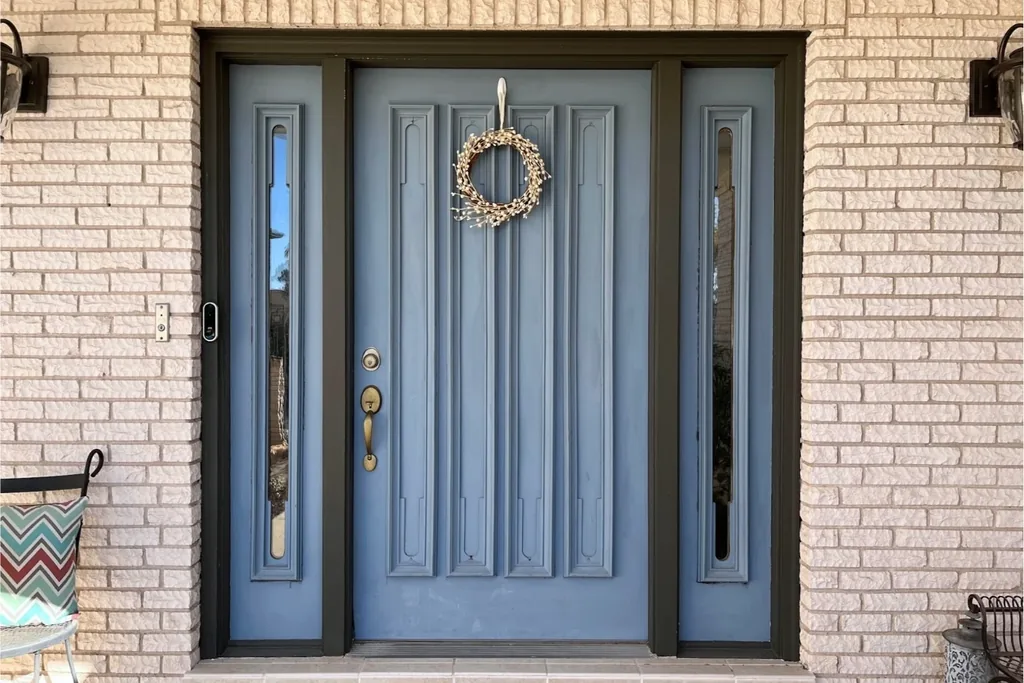 Front door painted chalky Wedgwood blue on a house exterior.