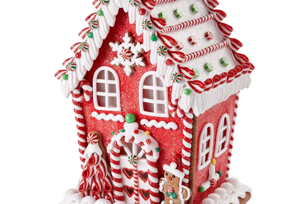 Red and white gingerbread style house decoration with candy details.