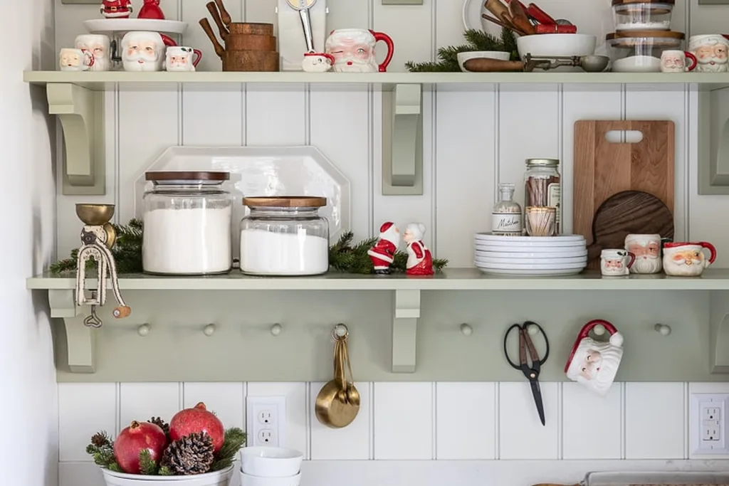 Kitchen open shelves with glass jars, mugs, and small Christmas accents.