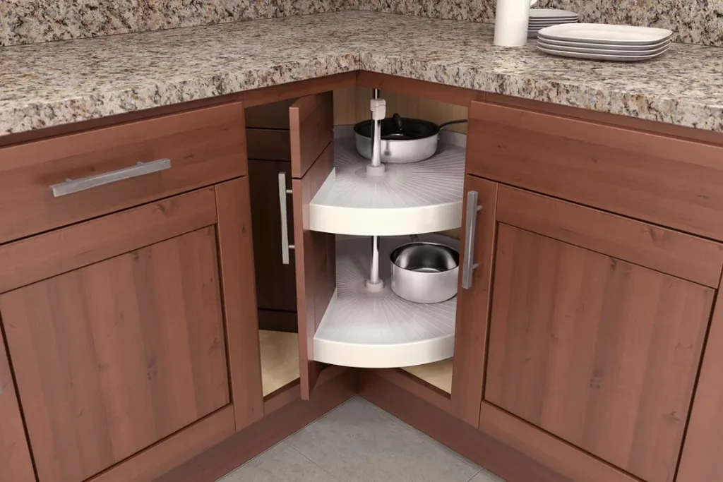 Round two tier lazy Susan shelves inside an open corner base cabinet.