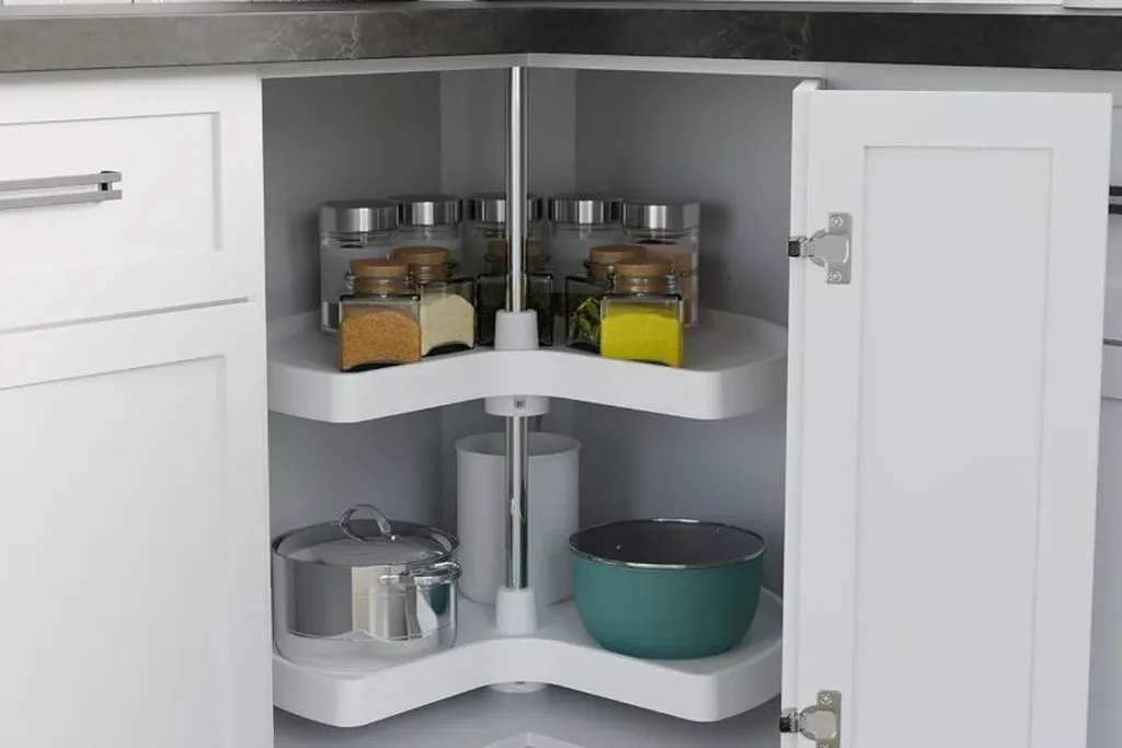 Kidney shaped corner shelves on a center pole holding spice jars, a pot and a mixing bowl.