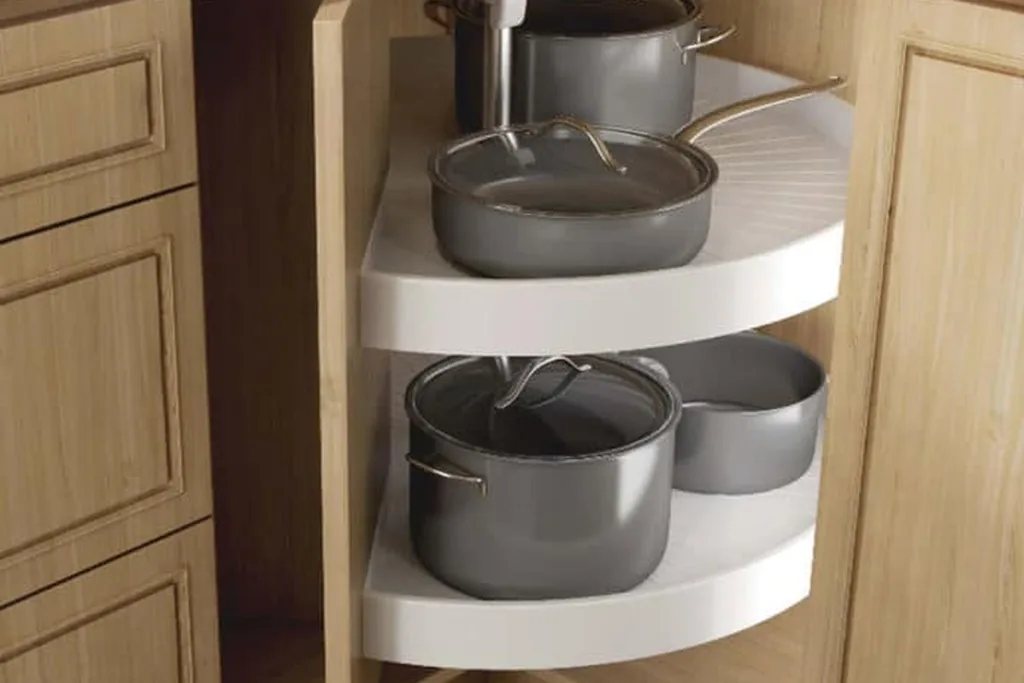 Turntable shelf inside a corner cabinet holding jars and cans.