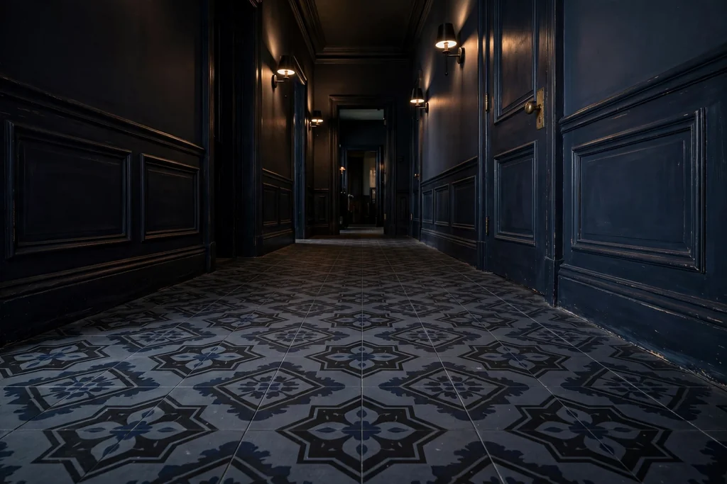 Dark hallway floor with patterned tiles in deep charcoal and navy.