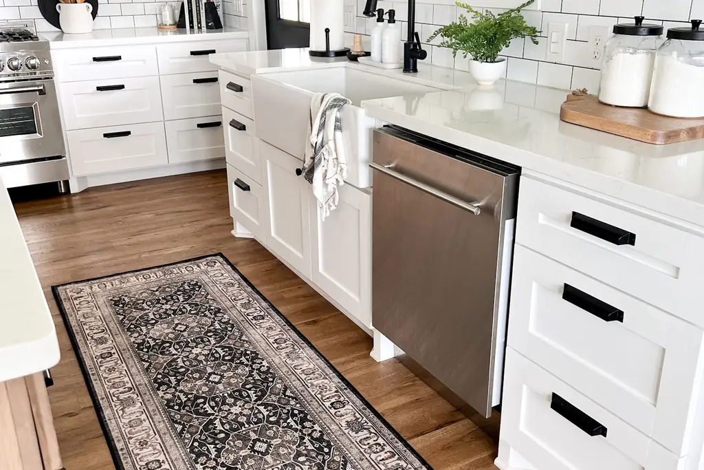 Washable runner rug in warm tones in front of a kitchen sink.