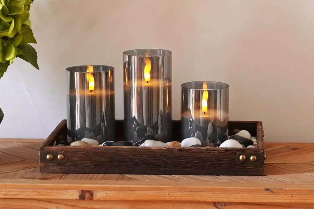 Flameless candles on a tray on a dresser.
