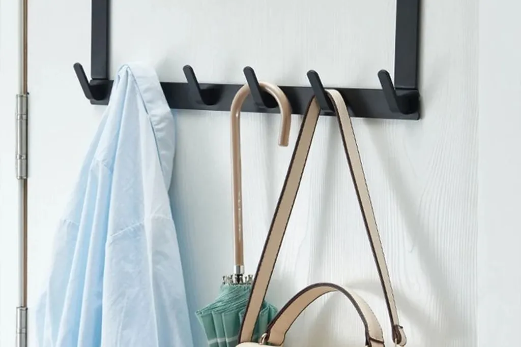 Hook rail with a scarf and a small felt pumpkin.