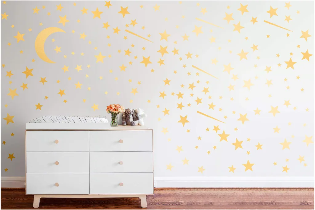 Moon and star decals above a dresser.
