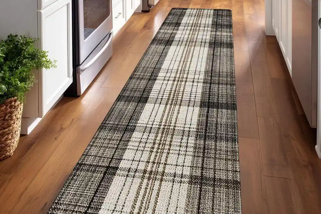 Black and cream plaid runner rug along a kitchen floor.