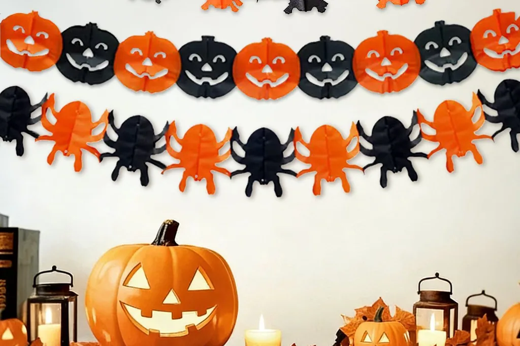 Felt Halloween garland with pumpkins, bats, and spiders above a mantel shelf.
