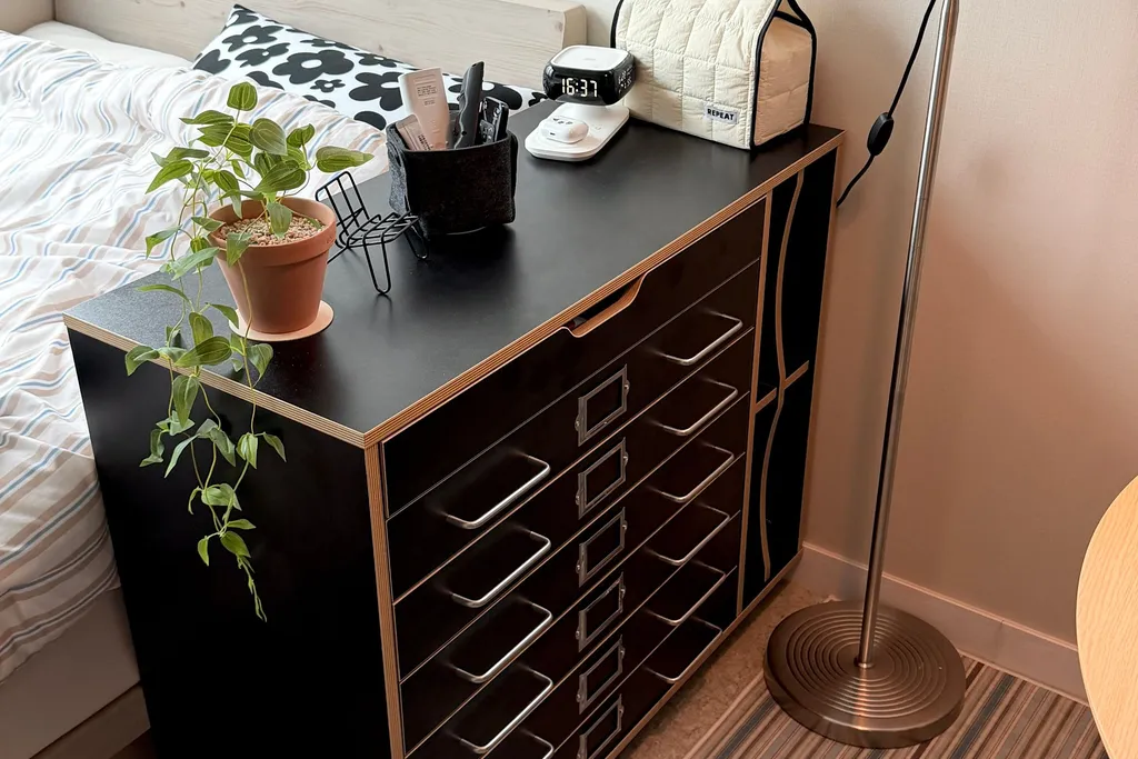 Nightstands with closed drawers and clear tops beside a bed