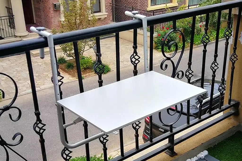 Fold-down table fixed to a balcony railing.