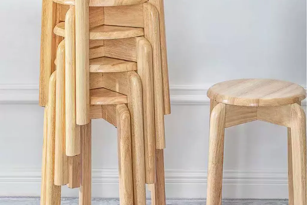 Stack of wooden stools beside a single stool.