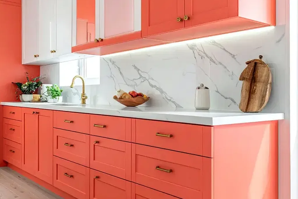 Kitchen with coral cabinets and white accents.