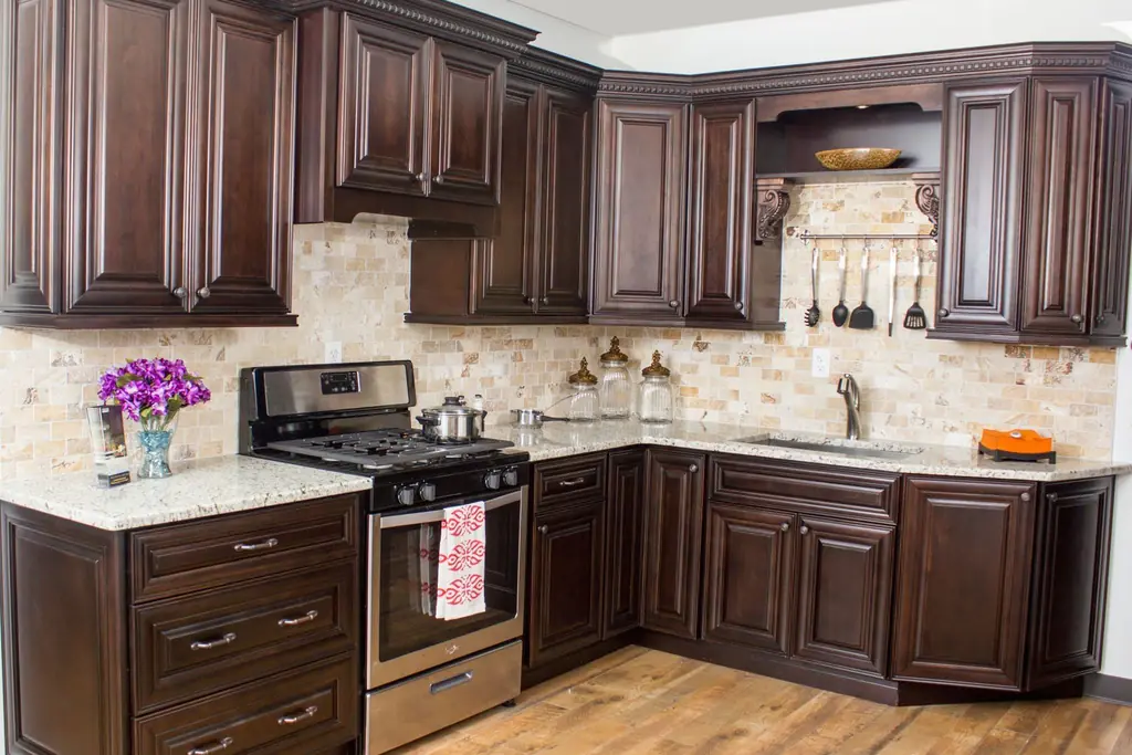 Kitchen with espresso brown cabinets and light counters.