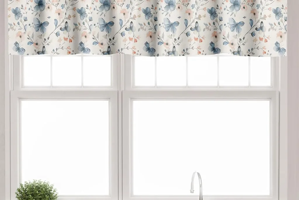 Short kitchen valance and tier curtains on a window above a sink.