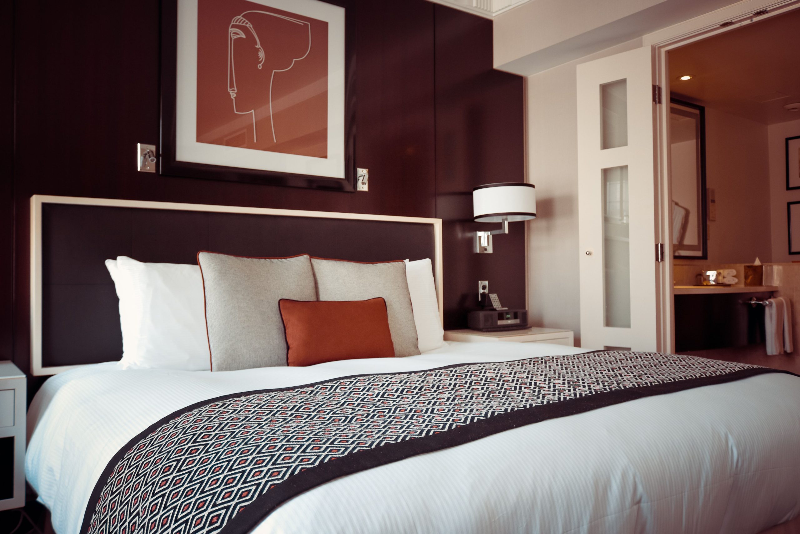 Inviting bedroom with neutral bedding and softly layered textures