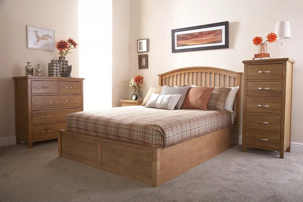 Plaid bedding paired with plain wood bedside tables and a wood dresser