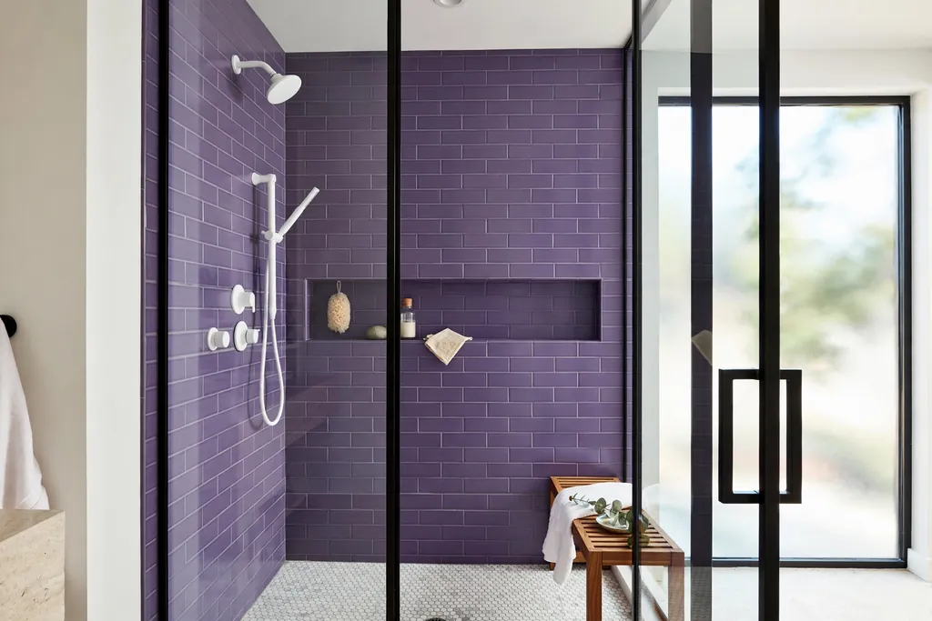 Shower with violet subway tile walls and white fixtures.